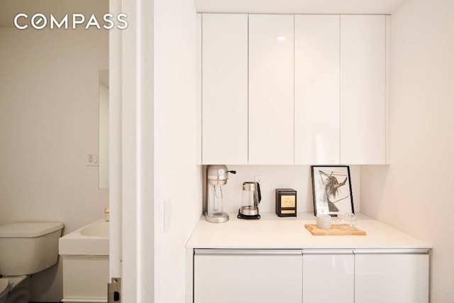 bar featuring white cabinets