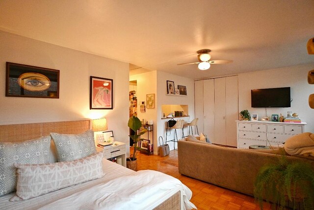 living room featuring parquet floors, a textured ceiling, and ceiling fan