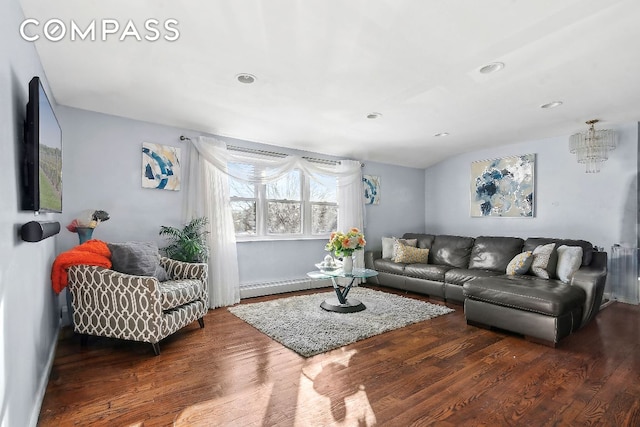 living room with dark hardwood / wood-style flooring and a baseboard heating unit