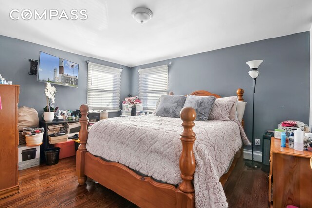 bedroom with dark wood-type flooring