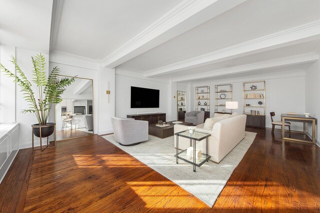 living area featuring baseboards, wood finished floors, crown molding, a fireplace, and beam ceiling