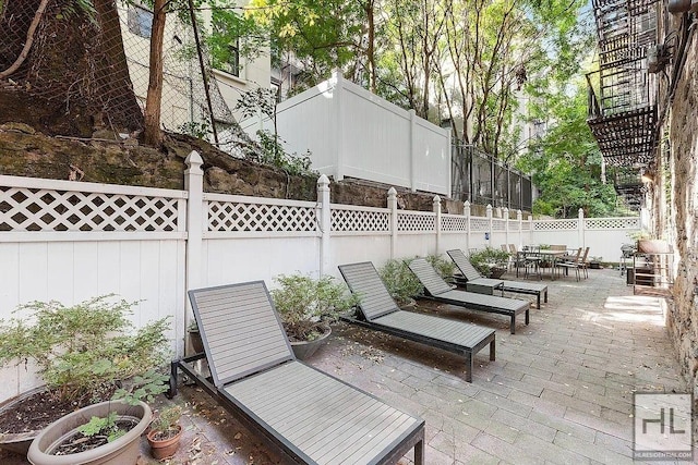 view of patio featuring outdoor dining area and a fenced backyard