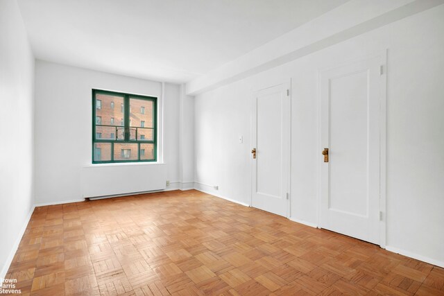 unfurnished bedroom featuring light parquet floors