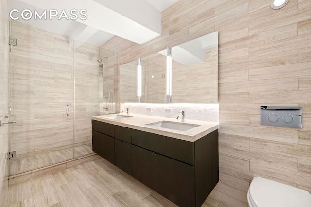 bathroom featuring tile walls, toilet, and walk in shower