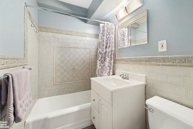 full bathroom with shower / tub combo with curtain, vanity, toilet, and tile walls