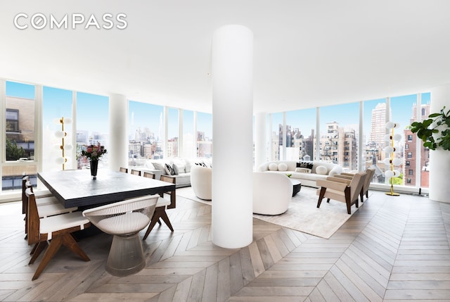dining area featuring a wall of windows and a city view