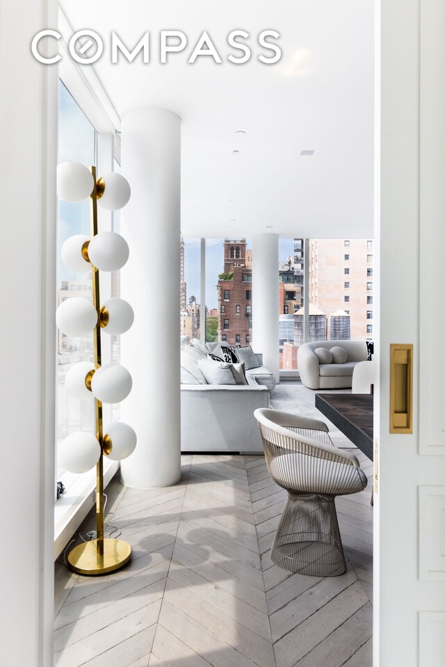 hall featuring ornamental molding and light parquet floors