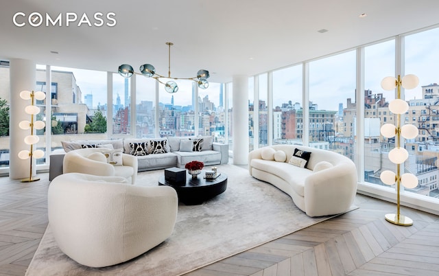 living room with a view of city, a notable chandelier, and expansive windows