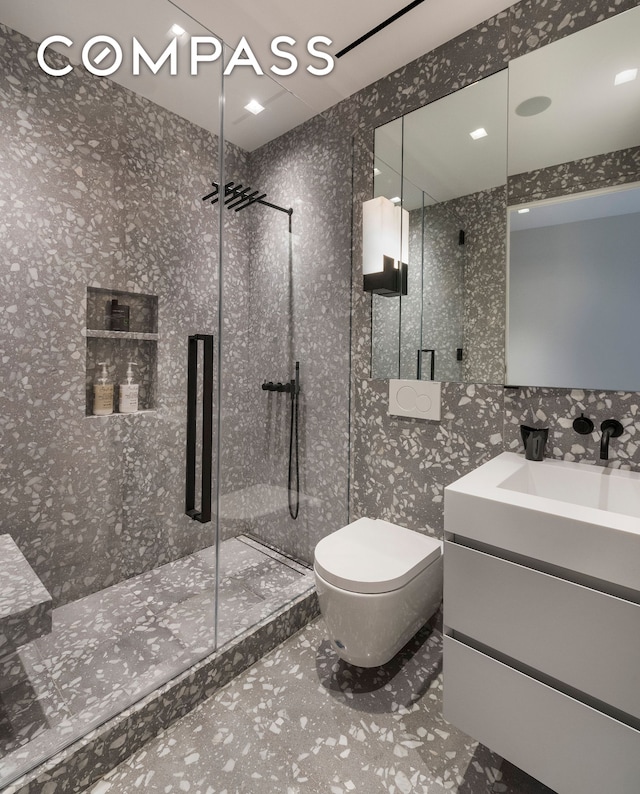 full bath with a stall shower, vanity, and toilet