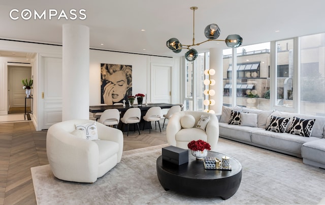 living room with decorative columns and recessed lighting