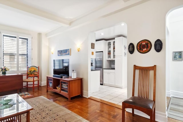 living room with parquet flooring and beam ceiling