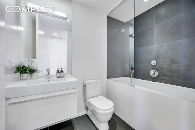 bathroom featuring tile patterned floors, shower / bath combination, toilet, and vanity