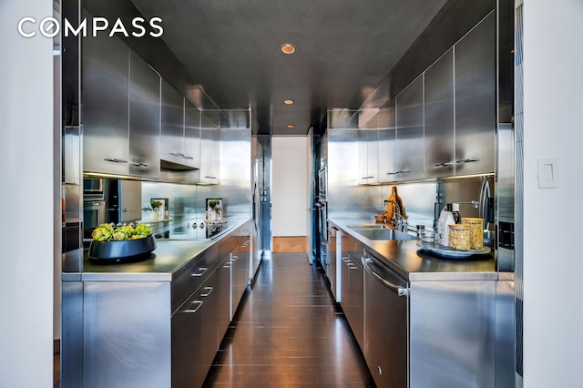 kitchen featuring a sink, black electric stovetop, stainless steel countertops, modern cabinets, and stainless steel dishwasher