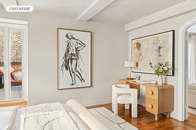 bedroom with wood-type flooring and beam ceiling