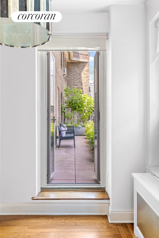 doorway with hardwood / wood-style floors