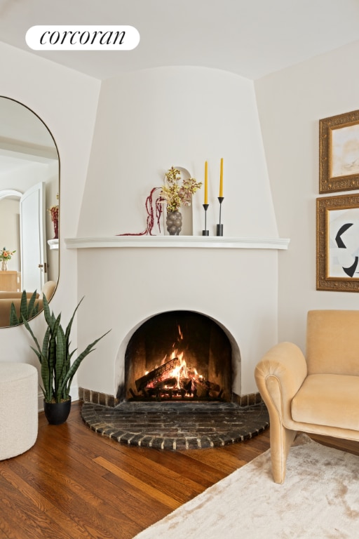 living area with wood-type flooring and a fireplace