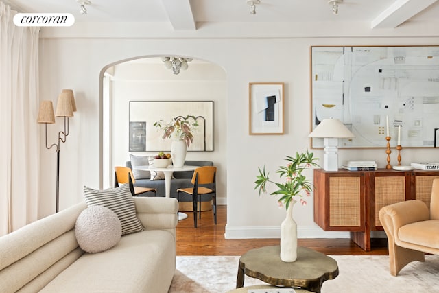 living area featuring hardwood / wood-style floors and beamed ceiling