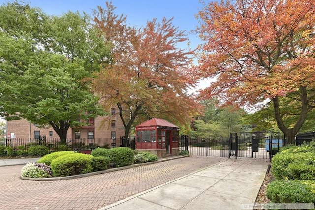 view of community featuring a gate, fence, and a gazebo