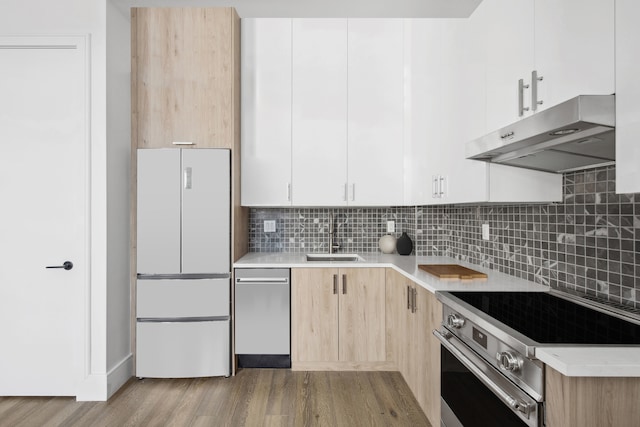 kitchen with appliances with stainless steel finishes, light countertops, and white cabinetry