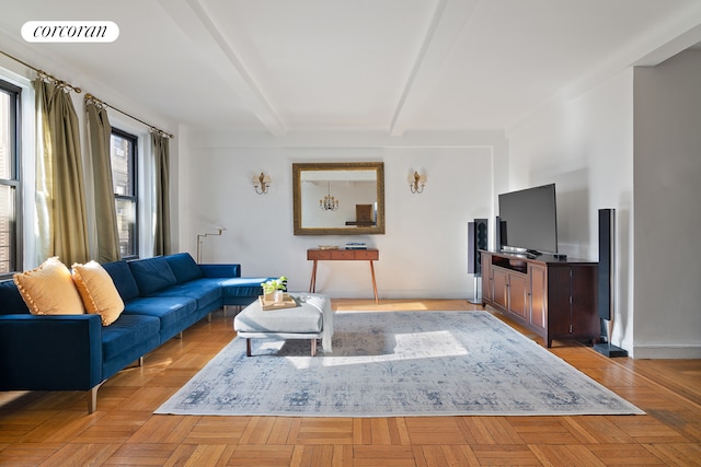 living room with beamed ceiling, baseboards, and visible vents