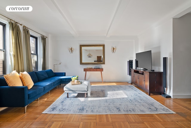 living room featuring beam ceiling and light parquet flooring