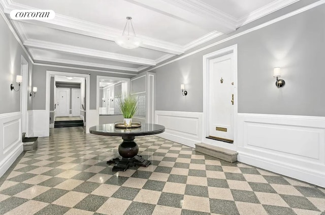 hallway with beamed ceiling, a decorative wall, visible vents, and wainscoting