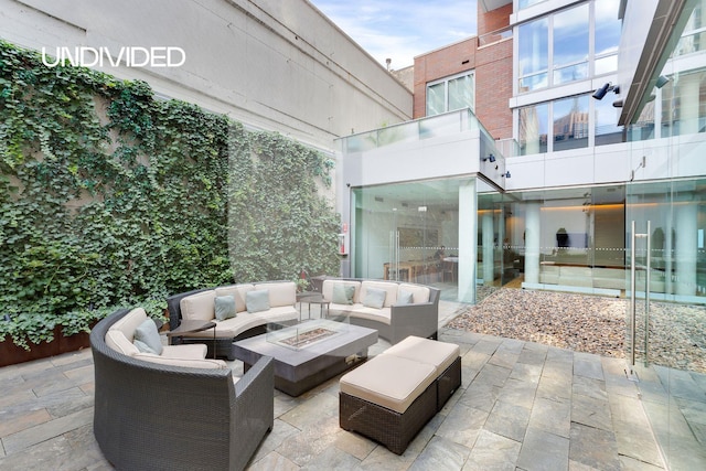 view of patio featuring an outdoor living space with a fire pit