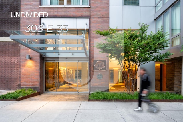 303 E 33rd St Unit 3G, New York City, NY 10016 - entrance to property with brick siding and a pergola