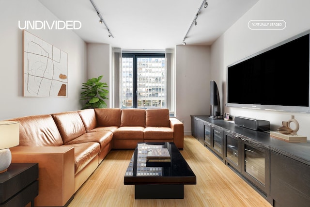 303 E 33rd St Unit 3G, New York City, NY 10016 - living area with track lighting and light wood-style floors