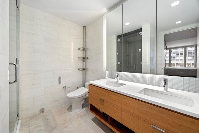 bathroom with double vanity, a stall shower, tile walls, and a sink