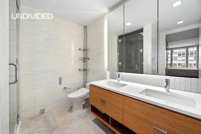 303 E 33rd St Unit 3G, New York City, NY 10016 - full bath featuring tile walls, a shower stall, double vanity, toilet, and tile patterned flooring
