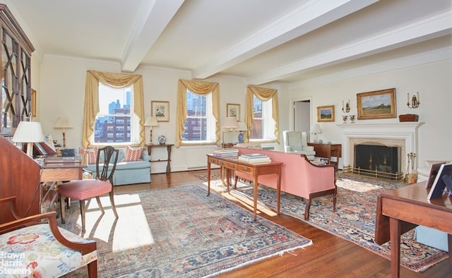 office with a fireplace, beamed ceiling, and wood finished floors