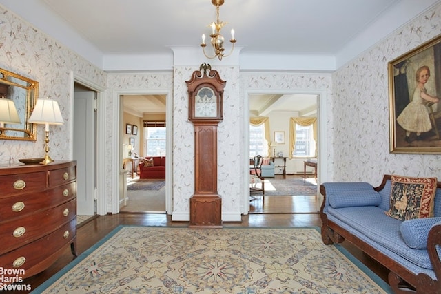 interior space with dark wood-type flooring, ornamental molding, and a notable chandelier