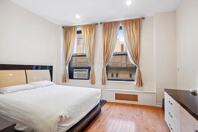 bedroom featuring cooling unit and light hardwood / wood-style floors