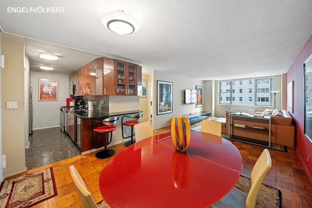 dining space featuring a textured ceiling