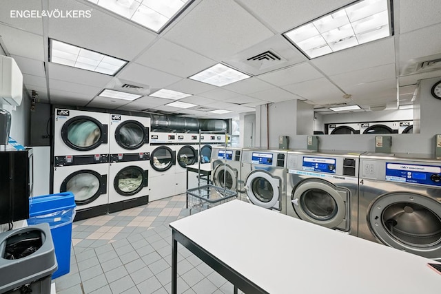 laundry area with stacked washer and clothes dryer and washer and dryer