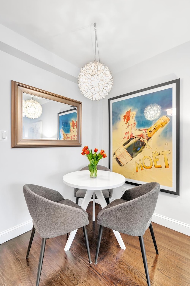 dining room with baseboards and wood finished floors