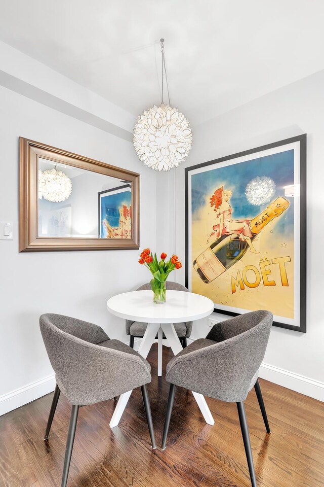 dining area with baseboards and wood finished floors