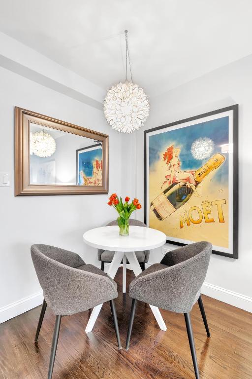 dining room with hardwood / wood-style flooring, breakfast area, and a notable chandelier