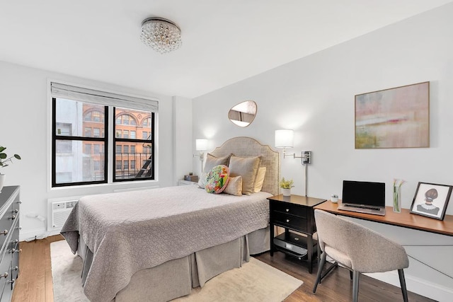 bedroom featuring hardwood / wood-style flooring and a wall mounted air conditioner