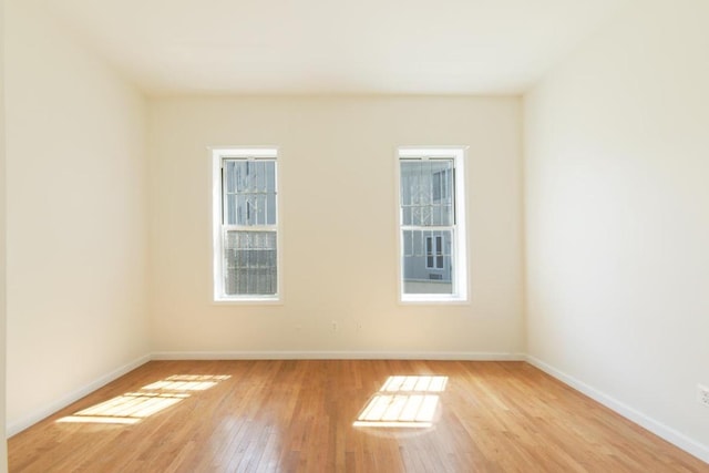 spare room featuring light wood-type flooring