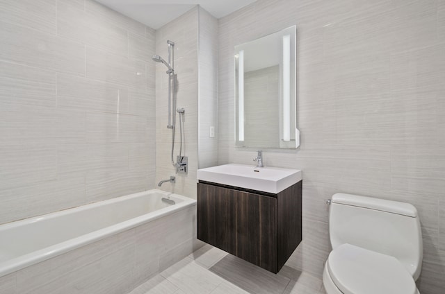 131-05 40th Rd Unit 11H, New York City, NY 11354 - bathroom with tiled shower / bath combo, tile walls, toilet, vanity, and tile patterned floors