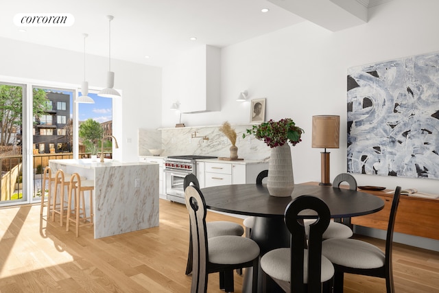 dining space featuring light wood-type flooring, visible vents, and recessed lighting