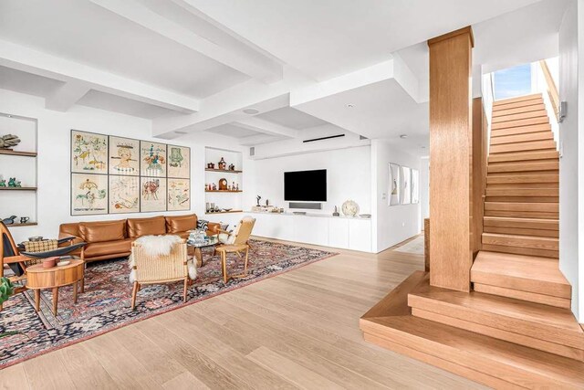 bar with sink, white cabinets, and light wood-type flooring