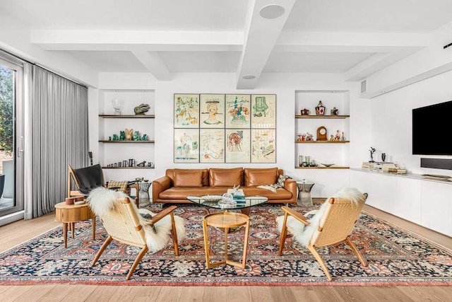 living room with hardwood / wood-style floors, built in features, and beamed ceiling