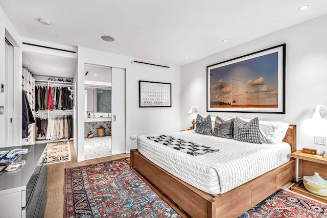 bedroom featuring hardwood / wood-style floors and a closet