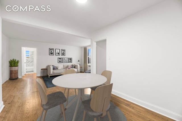 dining space featuring wood-type flooring