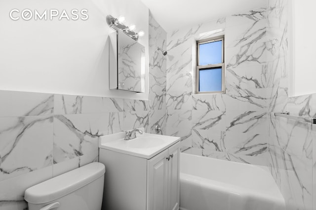 bathroom featuring tile walls, shower / tub combination, vanity, and toilet