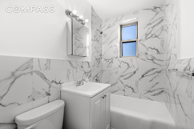 full bath featuring tile walls, shower / bathing tub combination, vanity, and toilet