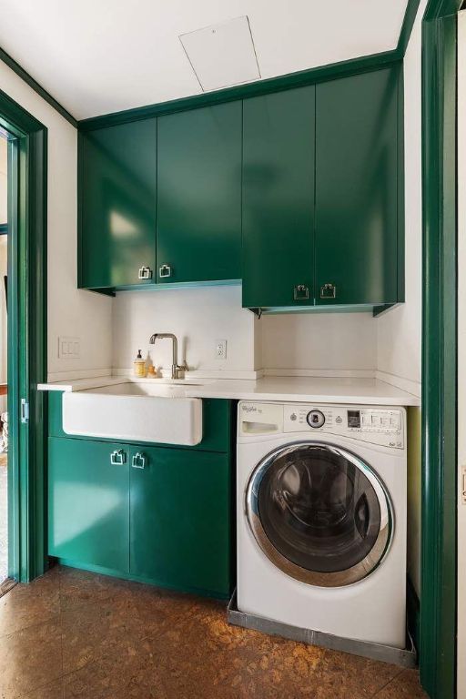 laundry area featuring cabinets, washer / dryer, and sink